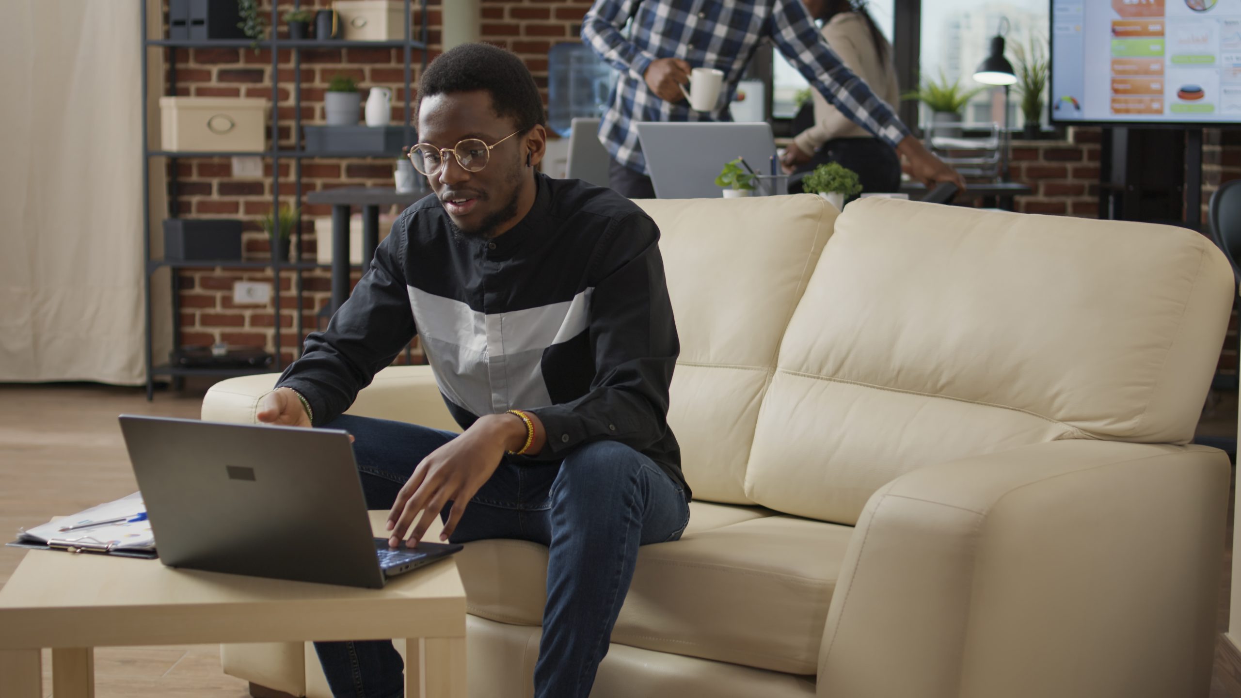 Male entrepreneur waving at videocall meeting webcam